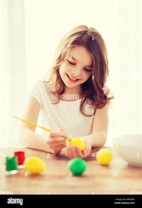 Smiling Little Girl Coloring Eggs For Easter Stock Photo Alamy