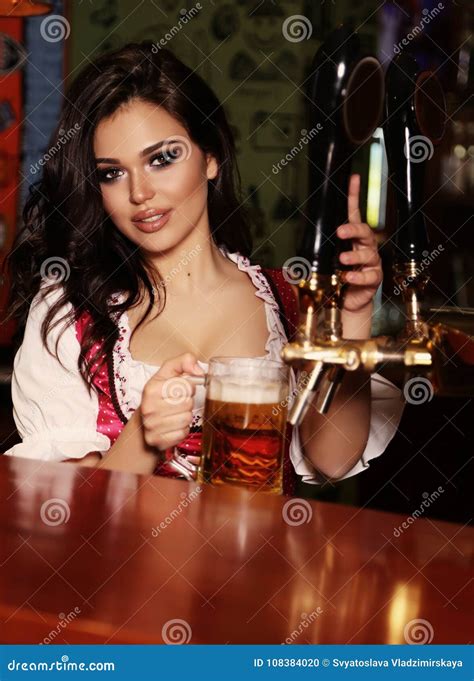 Woman Bartender Holding Glass With Cocktail Sprinkles On It And Masterfully Make Fire Stock