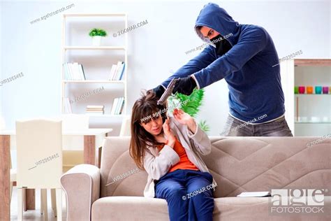 Armed Man Assaulting Young Woman At Home Stock Photo Picture And
