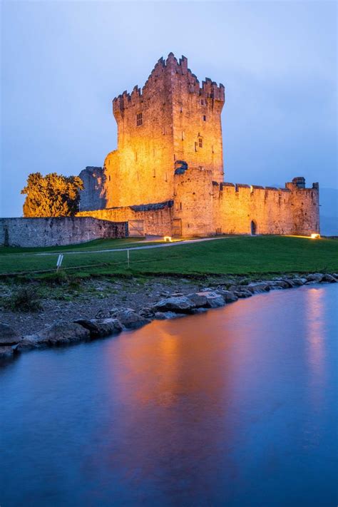 An Old Castle Is Lit Up At Night