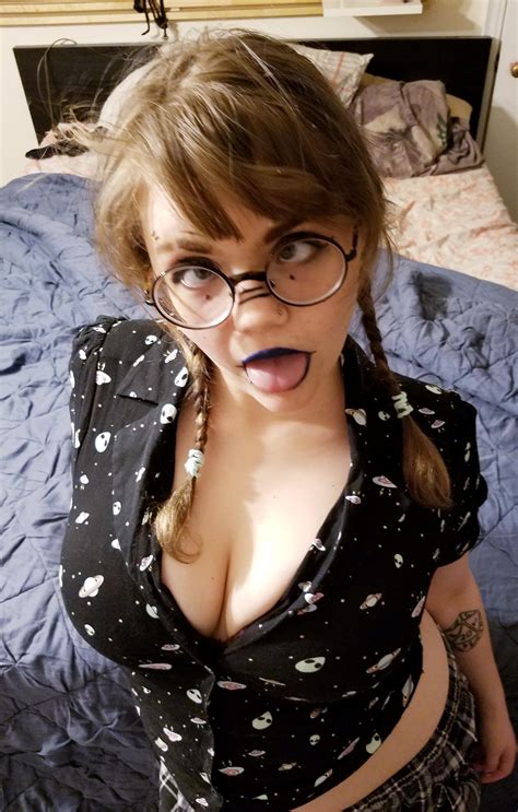 Nerdy Girl Sticking Out Her Tongue With Glasses And Dark