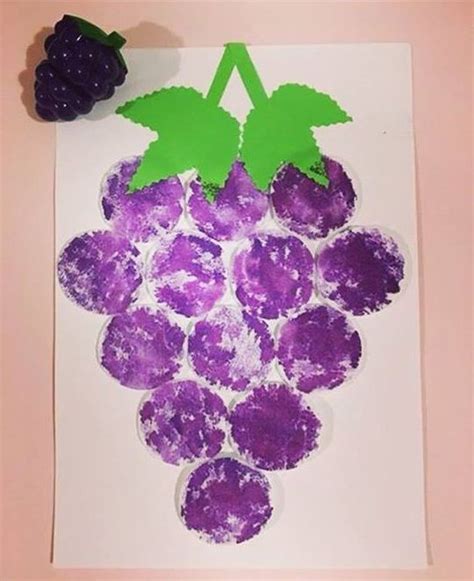 Grapes Made Out Of Paper With Green Leaves On Top And Purple Flowers In