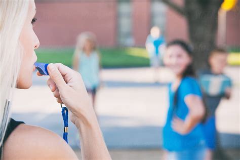 Recess Teacher Blows Whistle To End Recess By Stocksy Contributor