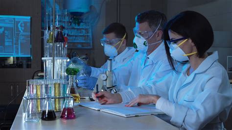 Group Of Chemists Working In Laboratory Stock Footage Sbv
