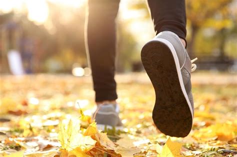 Premium Photo Feet Of Young Man Running In Autumn Park Closeup