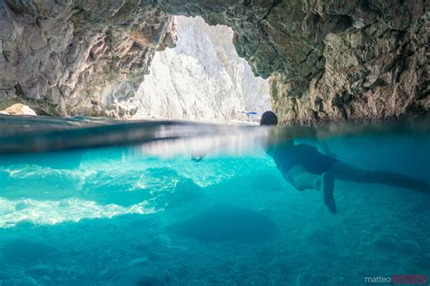 Boy Swimming In The Famous Blue Caves In The Island Of Zakynthos