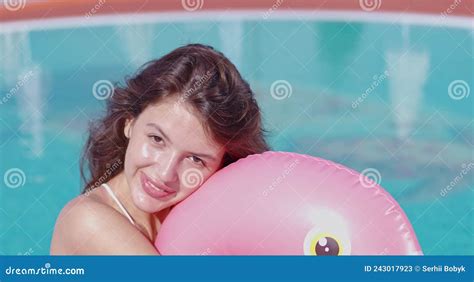 Woman In Bikini Swimming In Pool On Inflatable Flamingo Stock Video