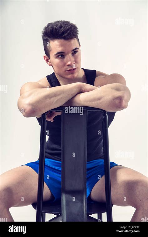 Handsome Young Muscular Man Sitting On Chair Stock Photo Alamy
