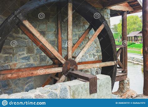 The Flow Of Water Rotates The Wooden Wheel At The Old Mill Stock Image