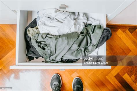 Pov One Person Standing In Front Of Messy Dresser Drawer High Res Stock