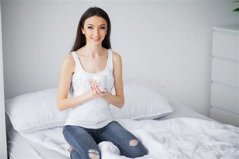 Good Morning Portrait Of A Smiling Pretty Young Brunette Woman Relaxing In White Bed Stock