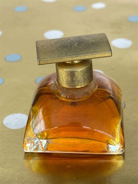 An Old Fashioned Perfume Bottle Is Sitting On A Polka Dot Tablecloth