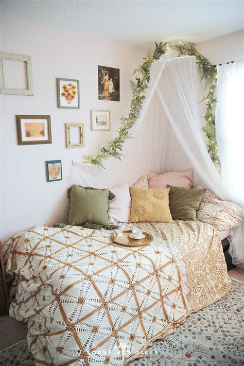 A Bed With A White Canopy Over It In A Bedroom Next To Pictures On The Wall