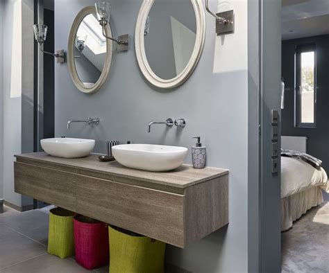 An ensuite is a bathroom that is linked to a bedroom, usually, the master bedroom, but they can be attached to any bedroom. This luxurious grey bedroom opens into a stunning ensuite ...