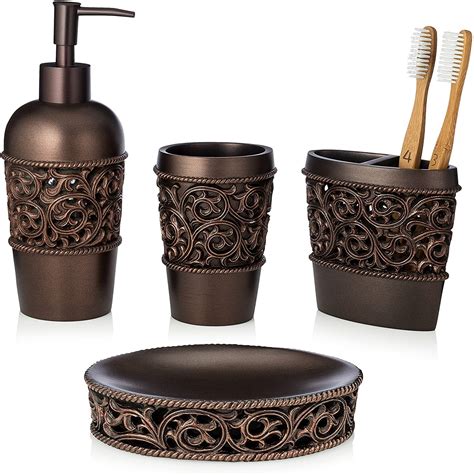 With toothbrush holder, soap dispenser, tray and soap dish. Essentra Home 4-Piece Bronze Bathroom Accessory Set ...