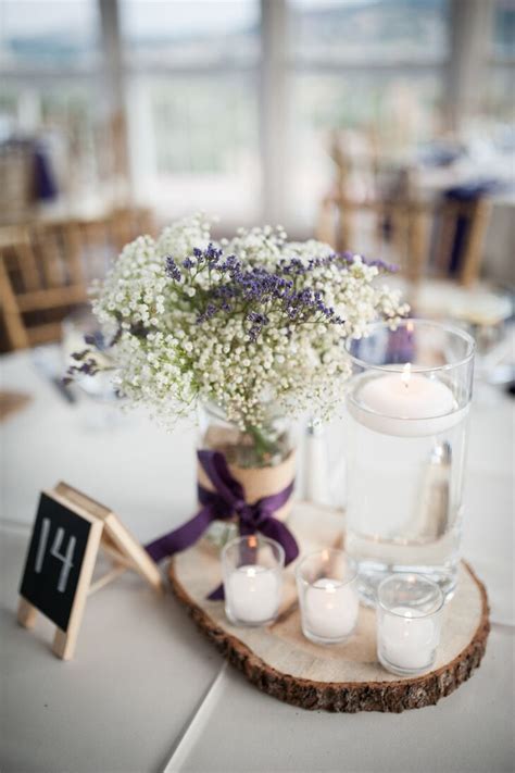 Rustic weddings often incorporate lots of natural wood decor, including repurposed items such as wine barrels made into cocktail tables or chairs. Rustic Baby's Breath and Floating Candle Centerpieces