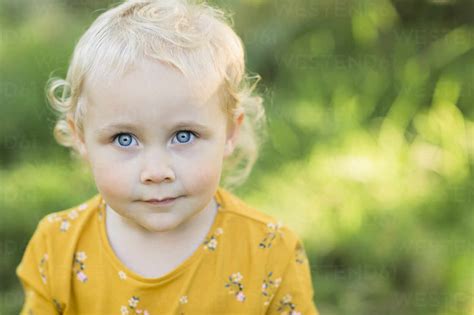 Portrait Of Blond Toddler Girl With Blue Eyes Stock Photo