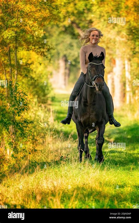 Beautiful Blonde Female Horse Rider On A Horse Without Sadle In The