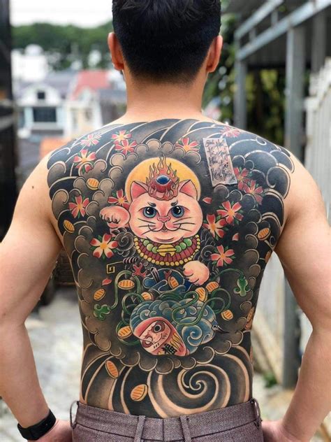 A Man With A Cat Tattoo On His Back
