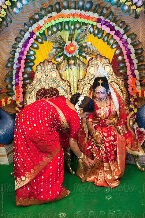 Indian Woman Adjusting Saree To Newly Married Bride By Stocksy