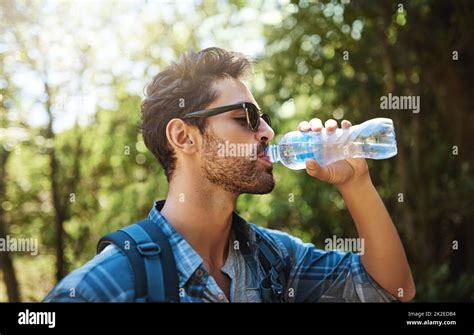 Staying Hydrated On His Hike Shot Of A Young Man Stopping For A Drink