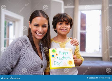 shes the best mom ever portrait of a son holding a mothers day card with his mom stock image