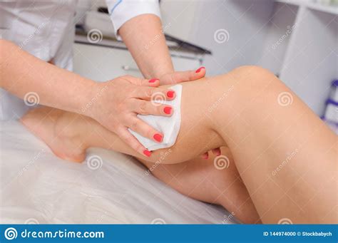 Closeup View Of Cosmetologist In Rubber Gloves Applying Wax On Leg