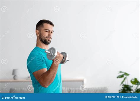 Serious Millennial Muscular European Guy Doing Arm Exercises Lifts