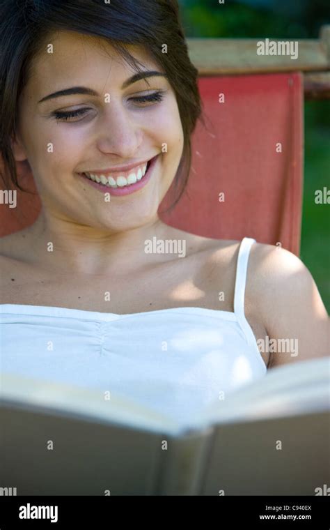 Smiling Woman Reading Book Stock Photo Alamy