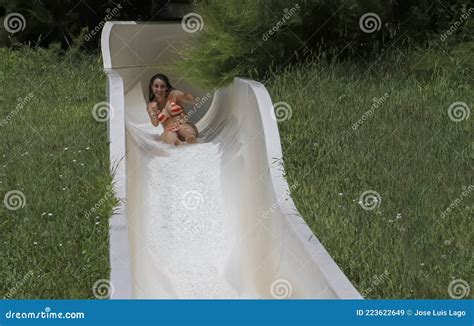 Girl In Bikini Having Fun When Falling Down Water Slide In Water Park Stock Image Image Of