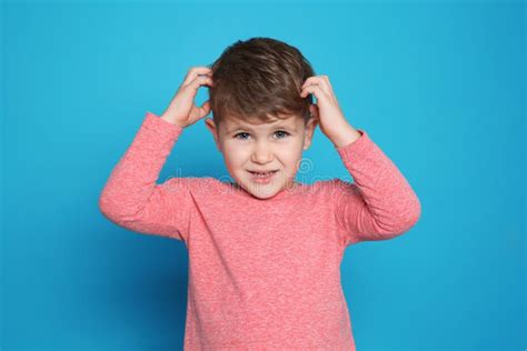 Little Boy Scratching Head On Color Background Stock Photo Image Of