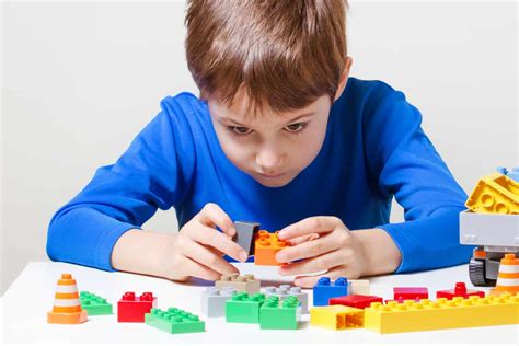 Child Playing With Colorful Plastic Construction Toy Blocks At The