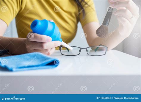 hand woman cleaning her glasses with cloth clean lenses of eyeglasses stock image image of
