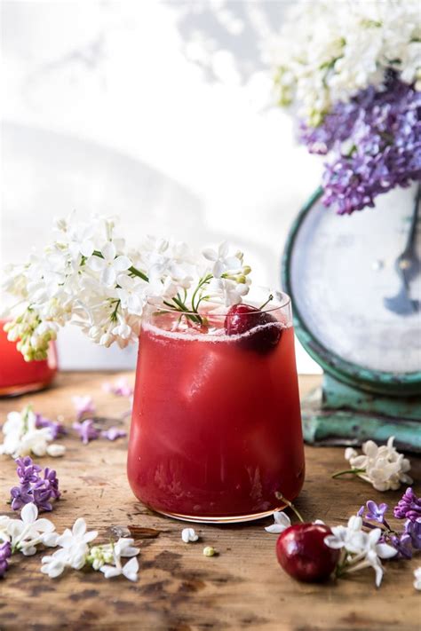Front On Close Up Photo Hibiscus Cherry Vodka Spritz With Lilacs