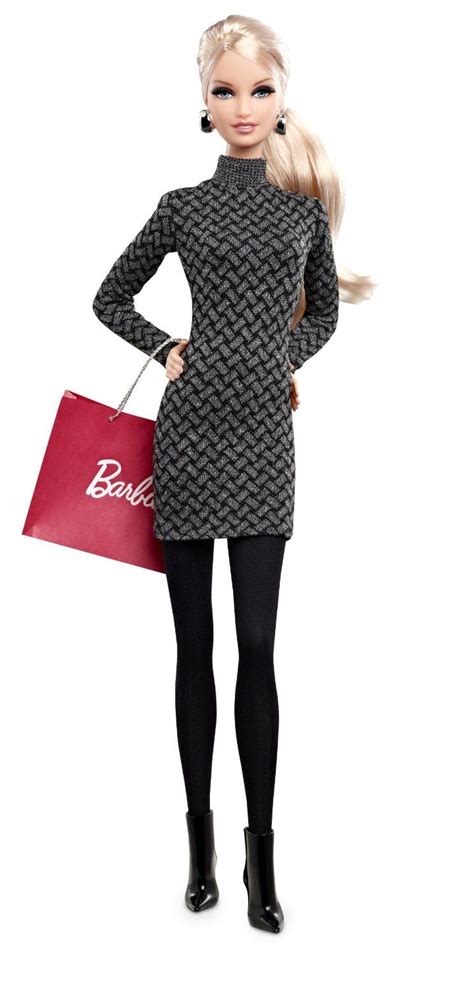 A Barbie Doll Is Holding A Red Shopping Bag And Posing For The Camera With Her Hands On Her Hips