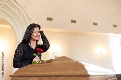 Crying Woman With Red Rose And Coffin At Funeral Stock Photo Adobe Stock
