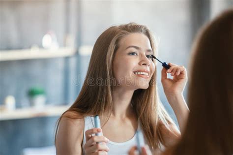 Beauty And Makeup Sweet Lady Applying Mascara On Her Eyelashes Near