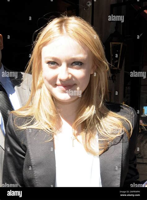 Dakota Fanning Signs Autographs And Poses For Photos With Fans While