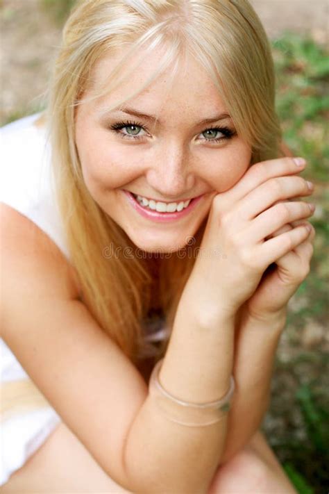 Charming Blonde Girl In Swimsuit Bikini Lying Down On Her Stomach Stock