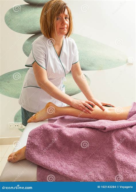 Masseuse Doing Legs Massage With Hot Stones Stock Photo Image Of Black Treatment