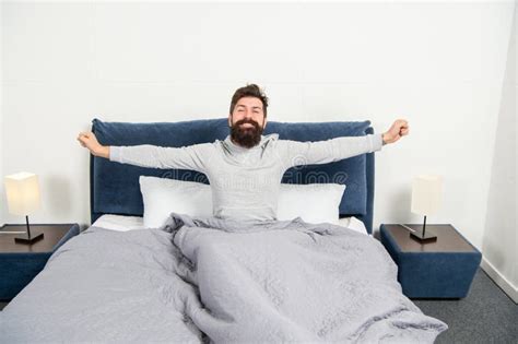 Happy Guy Smiling And Stretching In Bed Waking Up After Sleep Morning