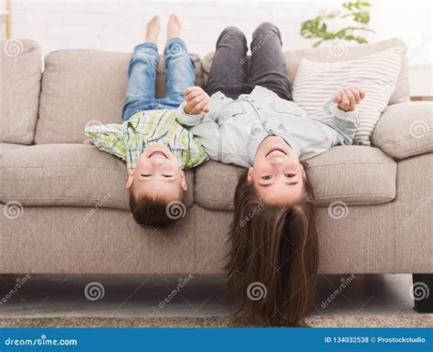Go Crazy Together Relaxing Upside Down On Sofa Stock Photo Image Of
