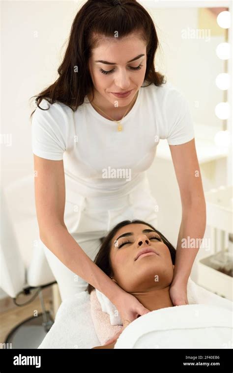 arab woman receiving head massage in spa wellness center beauty and aesthetic concepts stock