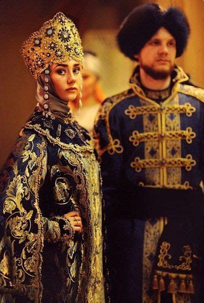 A Man And Woman Dressed In Costume Standing Next To Each Other