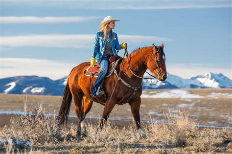 Cowgirl Riding Through Montana Mountains