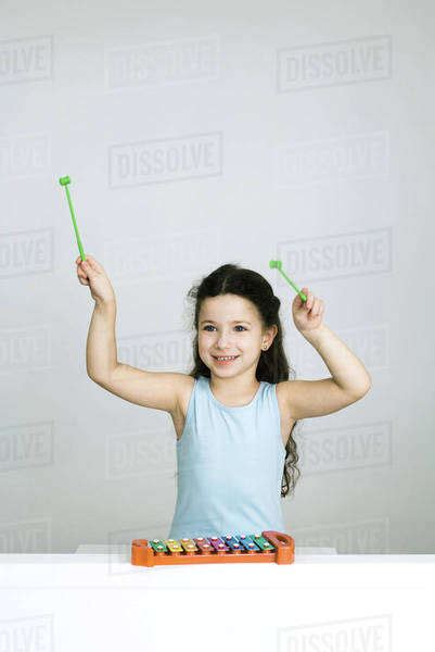 Little Girl Playing Xylophone Arms Raised Smiling Stock Photo