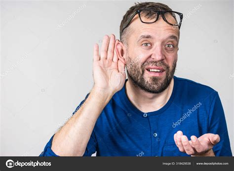 Man Eavesdropping With Hand Close To Ear Stock Photo By ©voyagerix