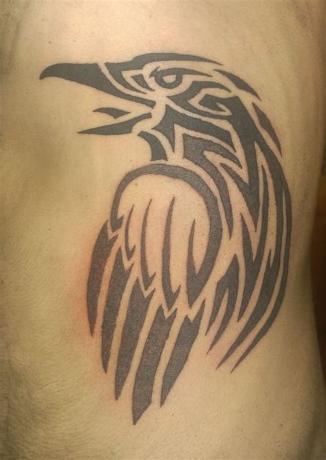 An Eagle Tattoo On The Side Of A Mans Stomach
