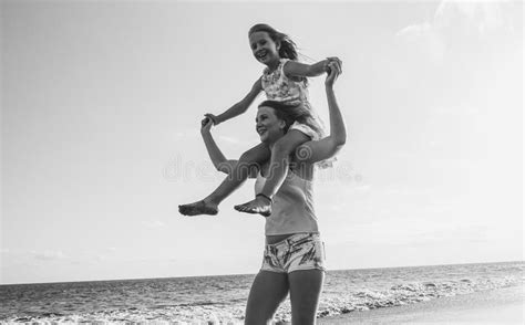 Mother And Daughter Having Fun On Tropical Beach Mum Playing With Her