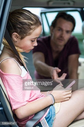 Daughter Ignoring Father While Using Mobile Phone In Car Parenting